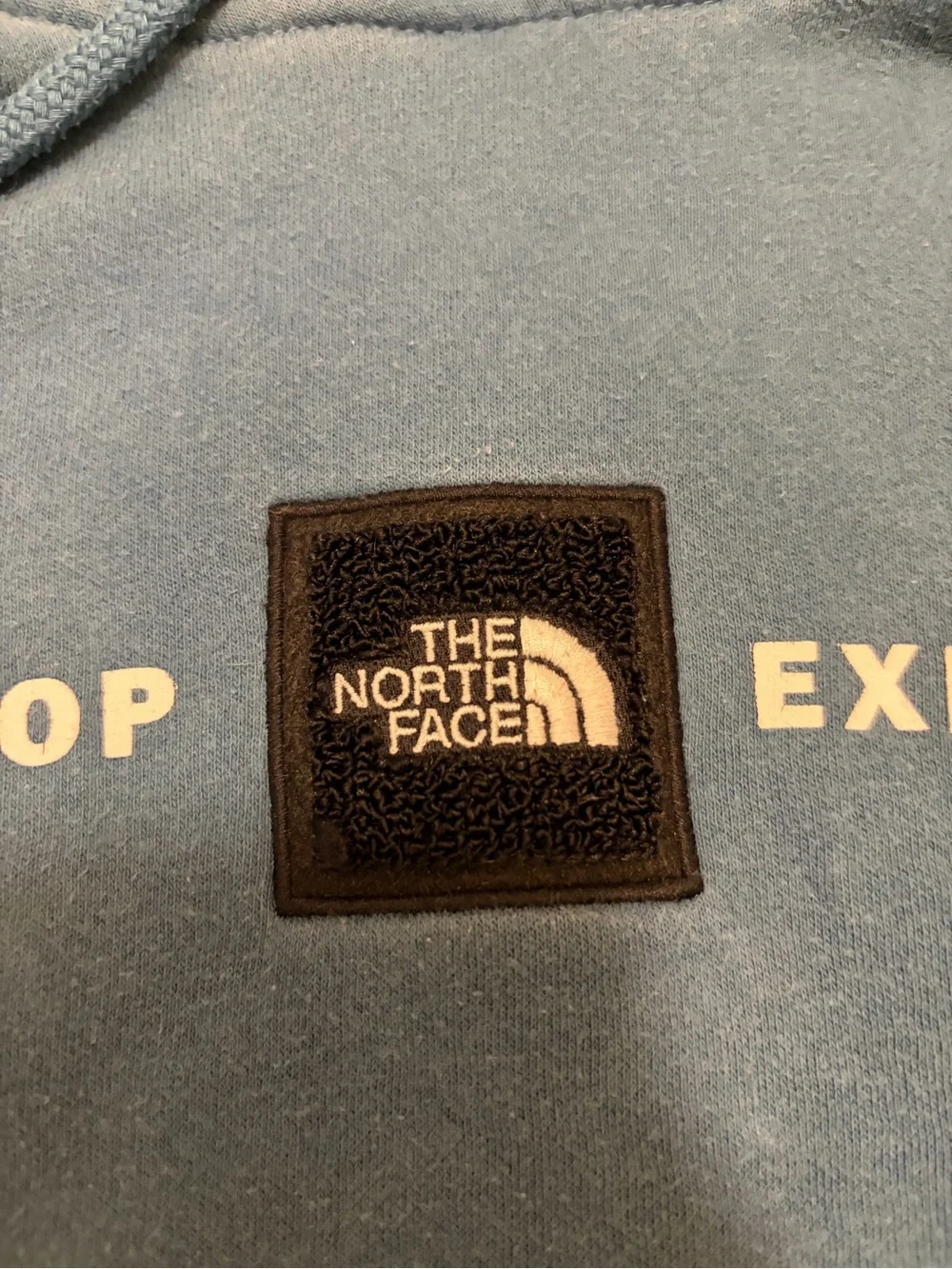 The North Face light blue pullover with black logo patch